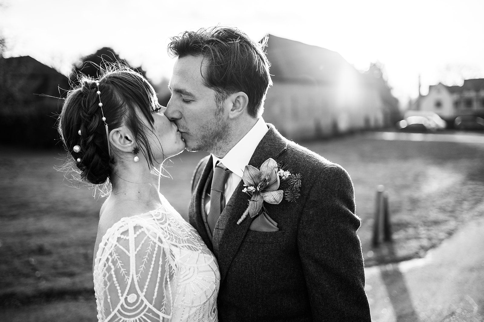 Pearl headbands for wedding - Bride and Groom kiss at their modern elegant rustic winter wedding