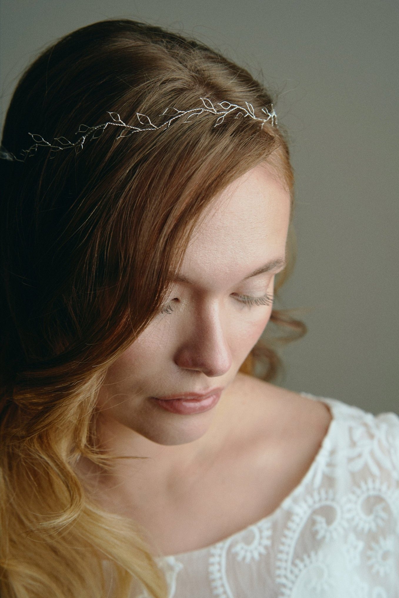 Model wears silver delicate leaf hair vine headband with long hair down