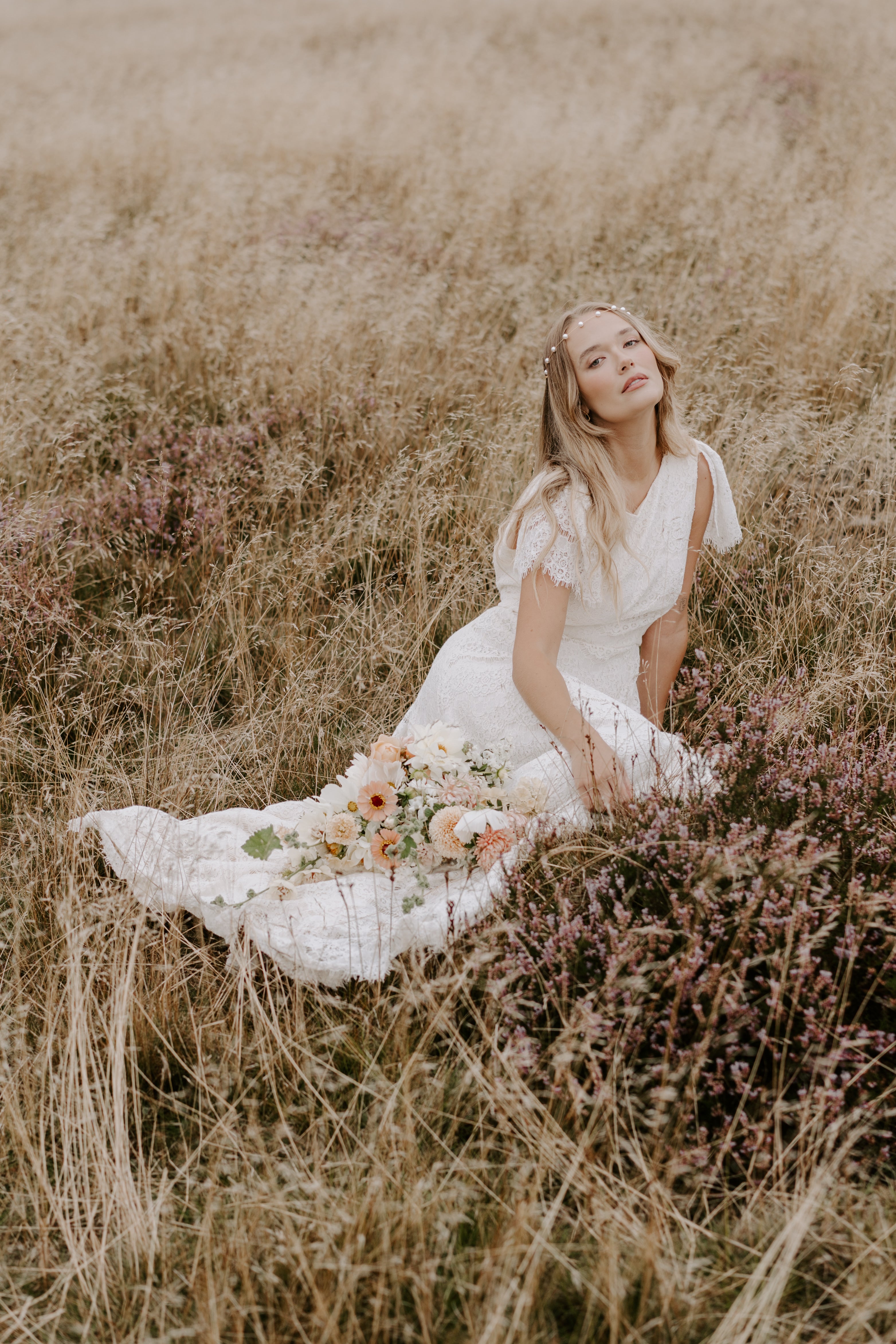 Model wears pearl forehead band in the heather 