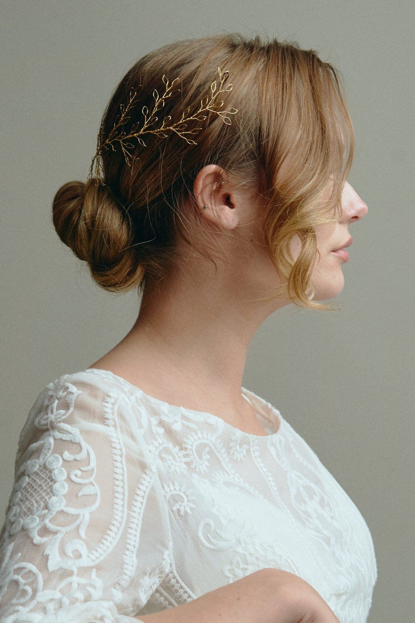 Model wears Large Leafy Hair Vine in gold in the back of her hair above a low bun