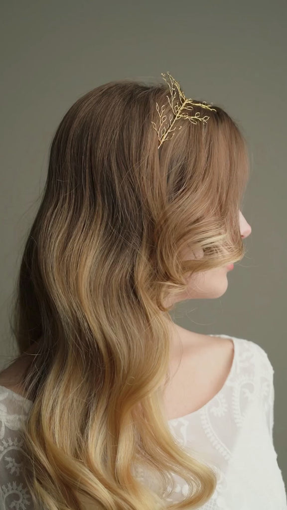 Model wears leaf crown in gold