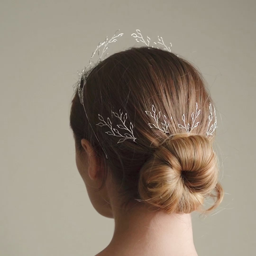 Model wears ethereal leafy silver hairpins and crown