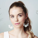 Mother of pearl flower wedding hair comb and bridal earrings set worn with high pony tail