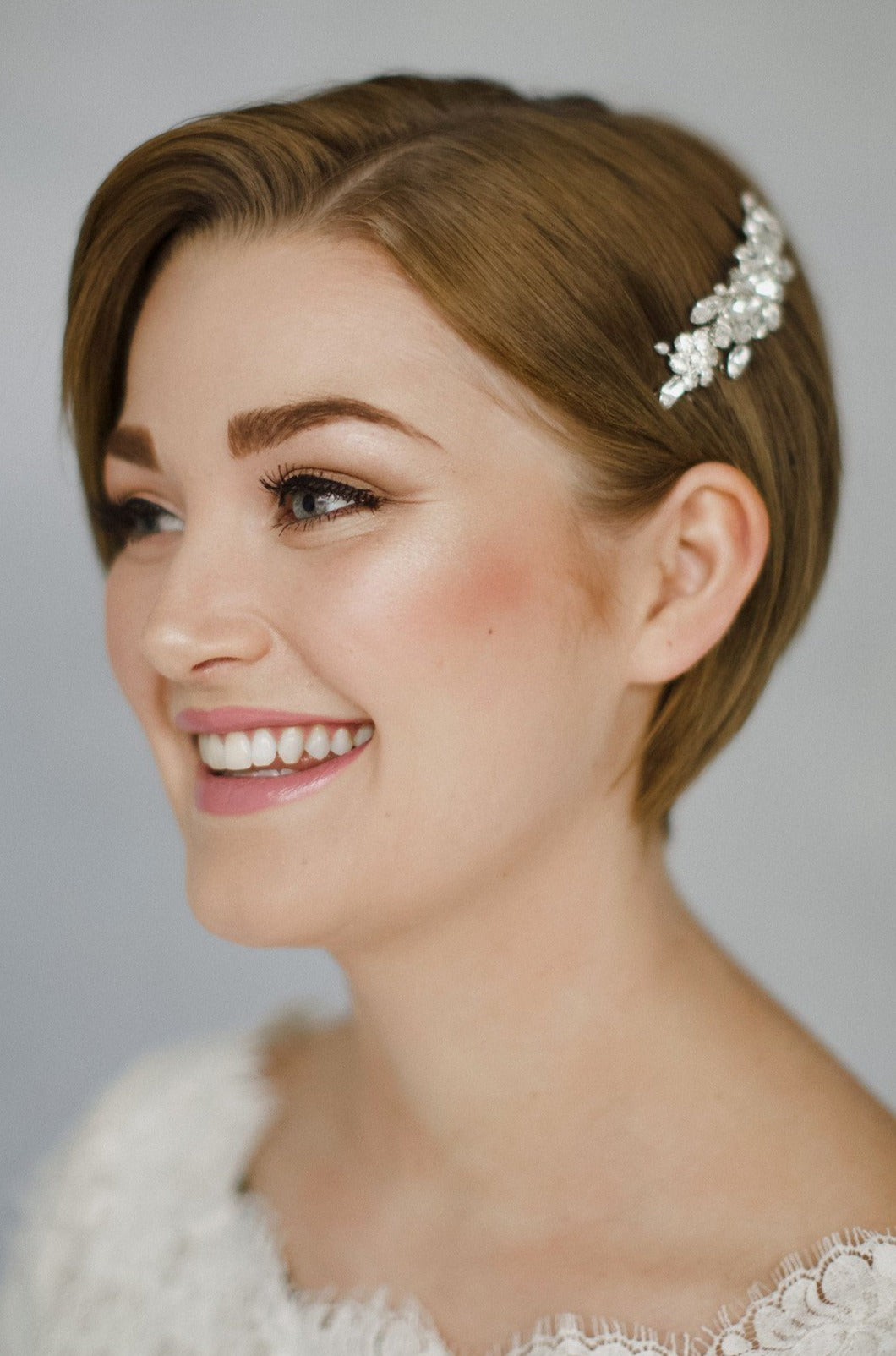 Short haired bride with pixie cut wears a vintage crystal wedding hair comb