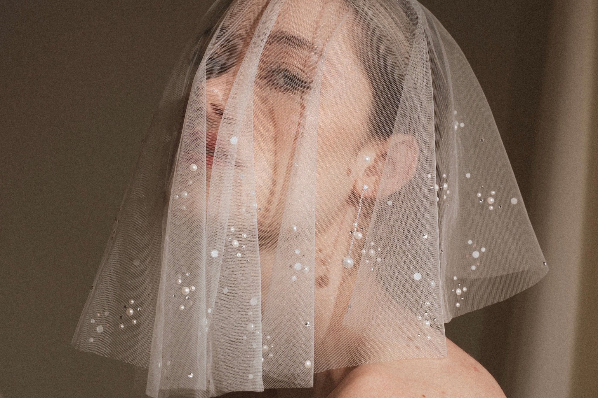 Bride wears pearl and crystal embellished micro veil