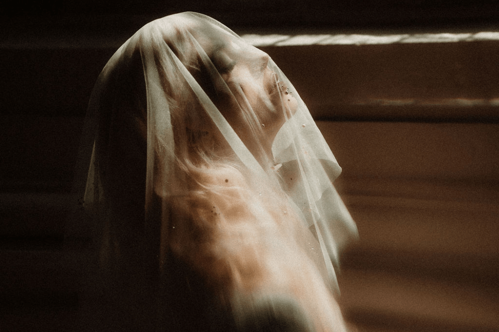 bride wears Katharina micro veil with light shining through and catching the crystals and pearls 