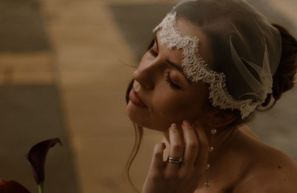 bride wears a romantic tulle micro veil with a fine French corded lace scallop edge trim in Juliet cap position