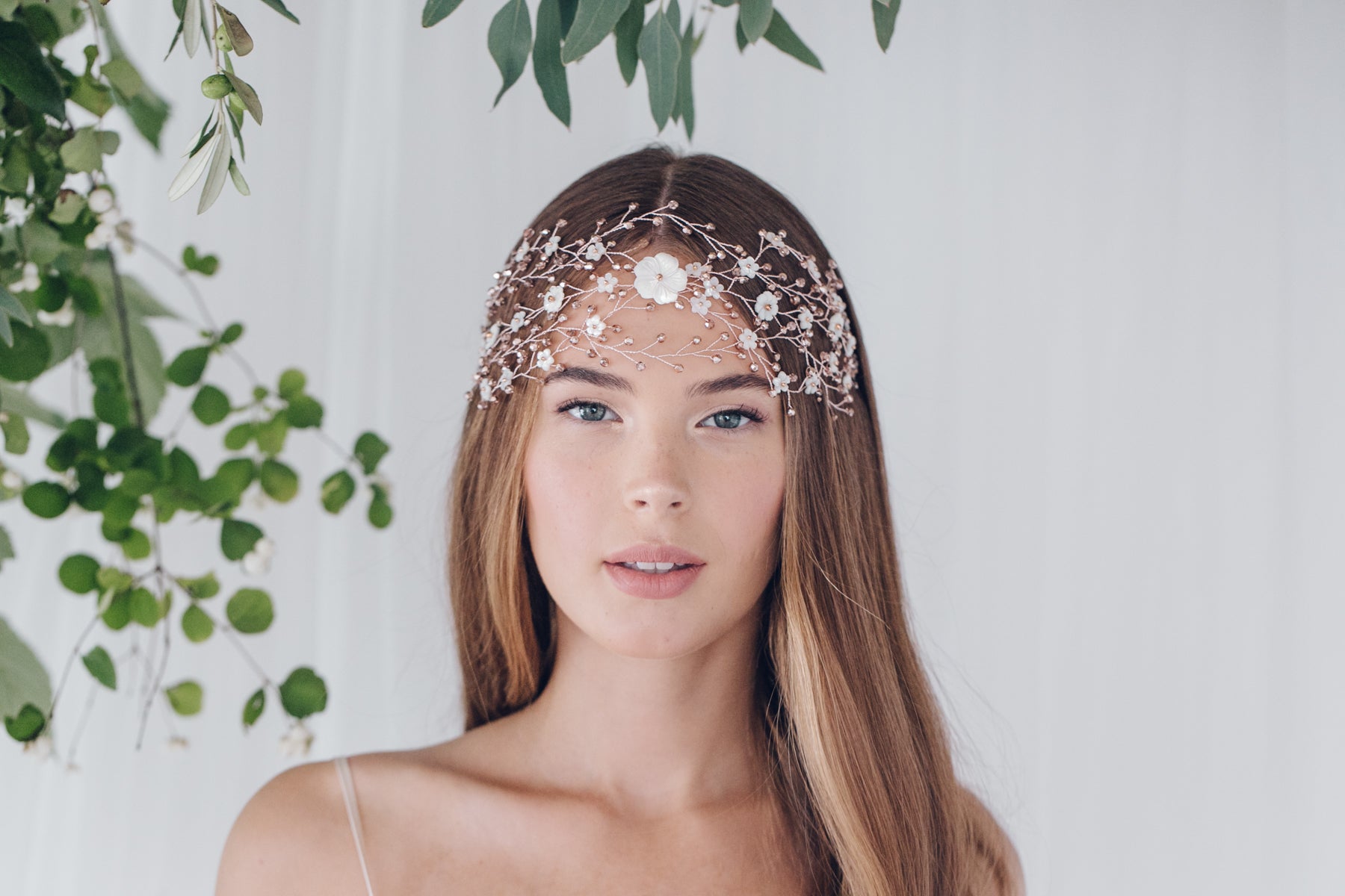 Model wears statement boho forehead vine in floral carved mother of pearl and rose gold crystals