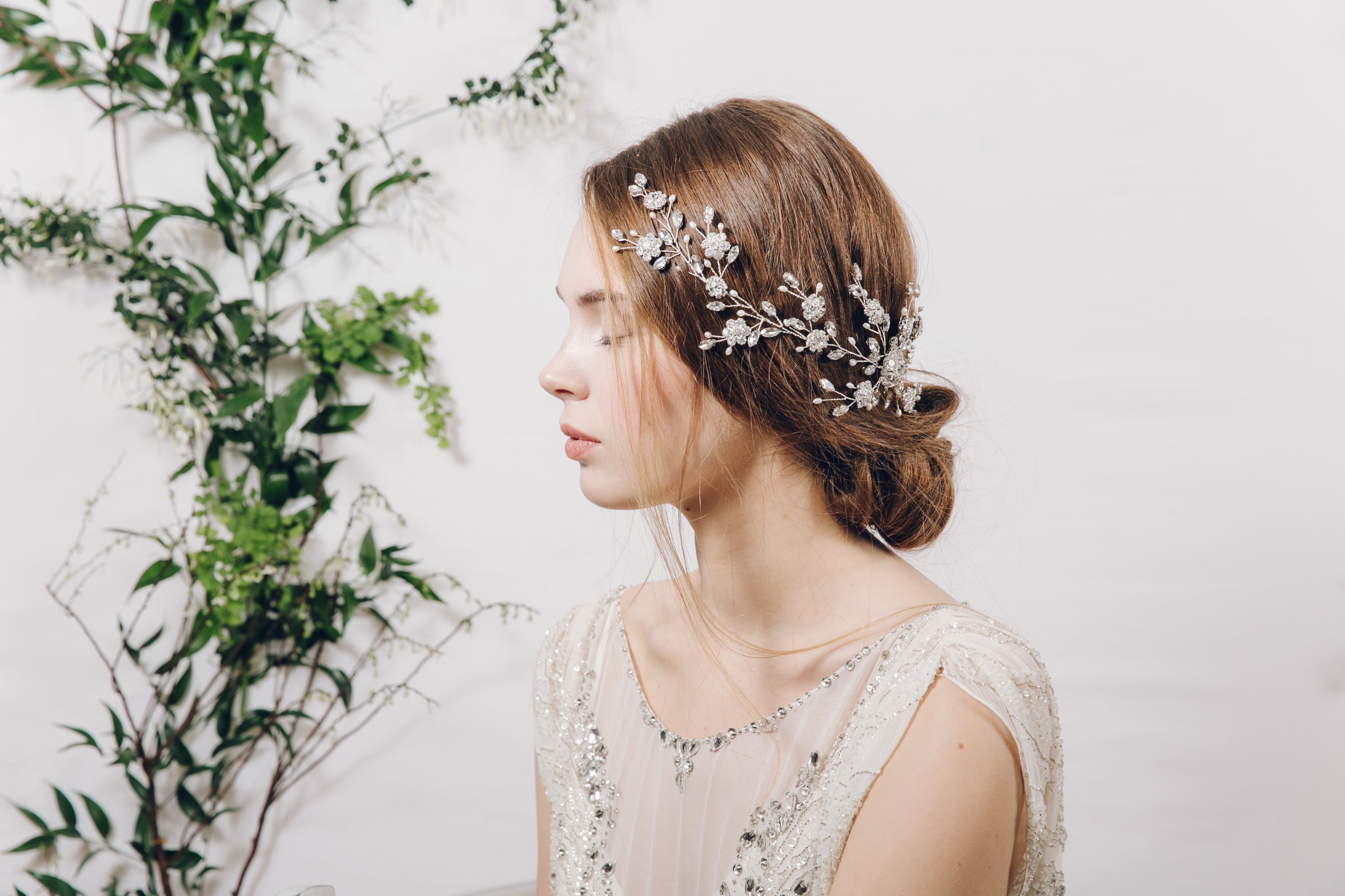 Bride wear botanical floral silver crystal hair vine with loose natural low bun