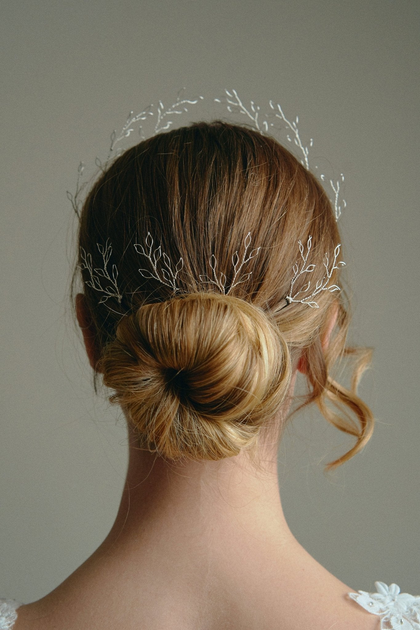 Model wears leaf crown in silver with matching leaf hairpins