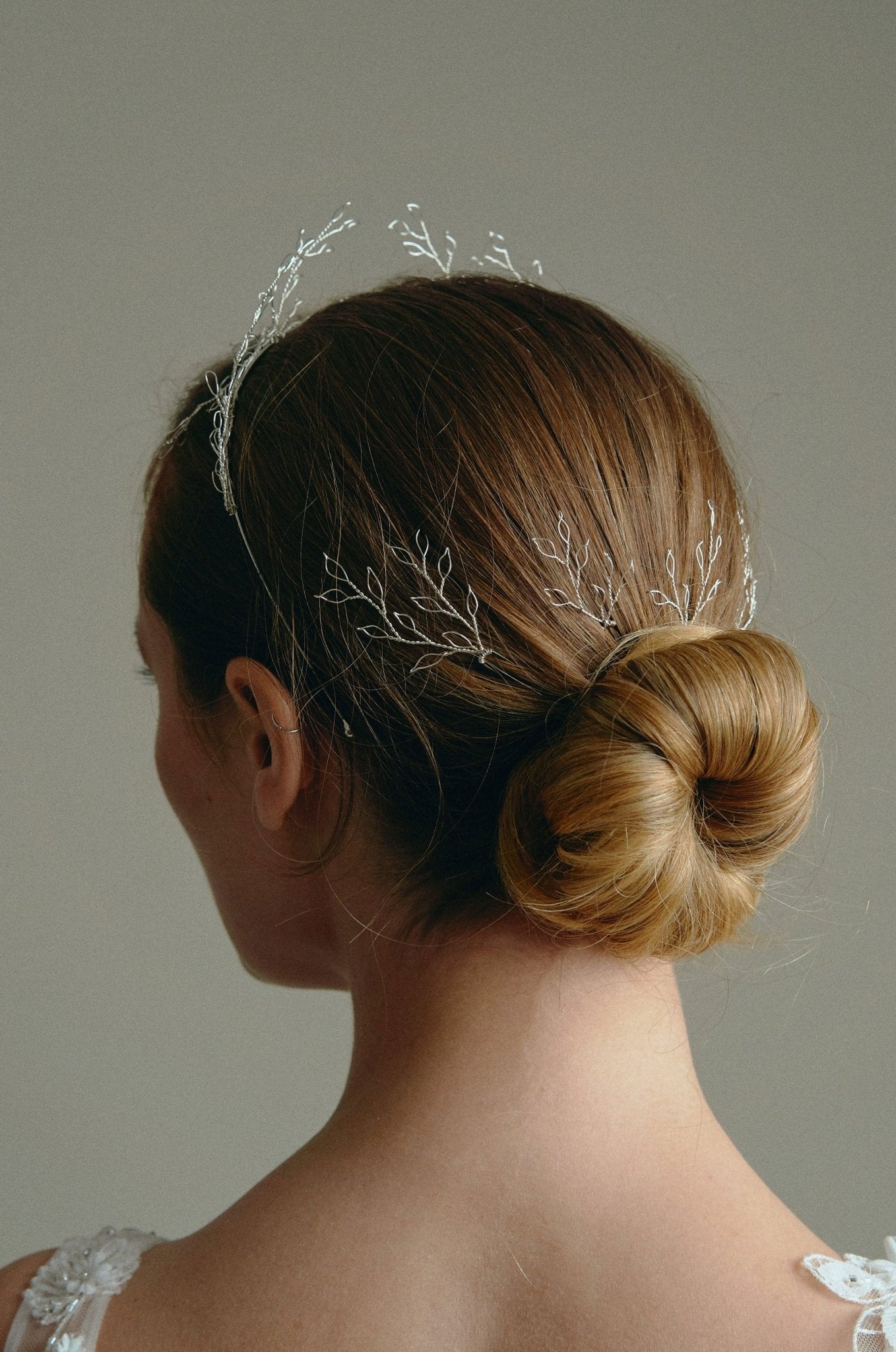 Model wears leaf crown in silver with matching leaf hairpins