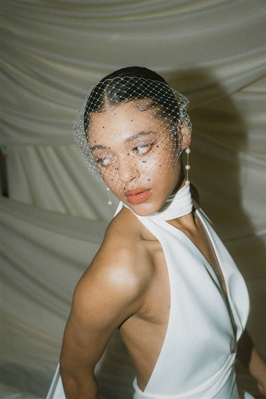Bride wearing a crystal embellished birdcage veil 