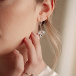 Close-up of a woman wearing a silver crystal earring