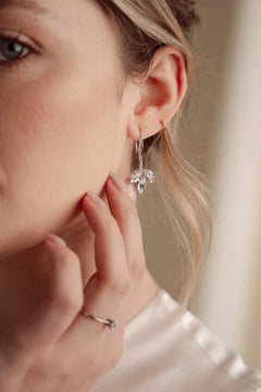 Close-up of a woman wearing a silver crystal earring