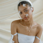 Betsy Ivory Birdcage Veil With 3D Silk Flowers worn with the Esther ivory satin padded headband