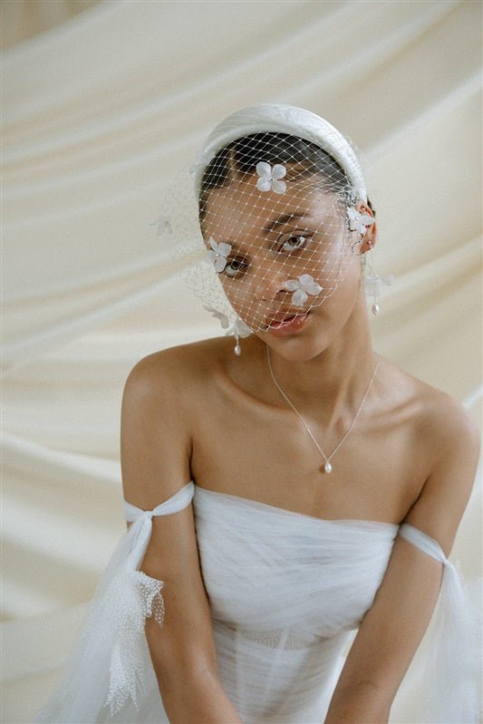 Betsy Ivory Birdcage Veil With 3D Silk Flowers worn with the Esther ivory satin padded headband