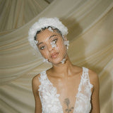 Betsy Ivory Birdcage Veil With 3D Silk Flowers worn with the Florence silk flower padded headband
