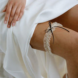 the Bonnie garter with its exquisite ivory tulle gathered fabric finished with a simple slim black or ivory satin bow
