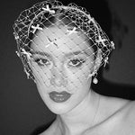 bride wears a bow birdcage veil on a slim headband - black and white film image