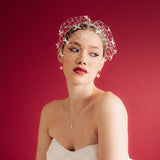 bride wears a bow birdcage veil on a slim headband