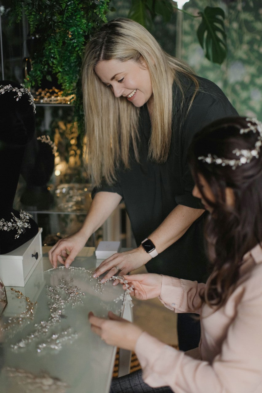 Bridal accessories designer Debbie Carlisle helps a bride to choose a hair accessory during a consultation at her studio 