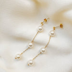 round sustainable pearl drop earrings with gold chain