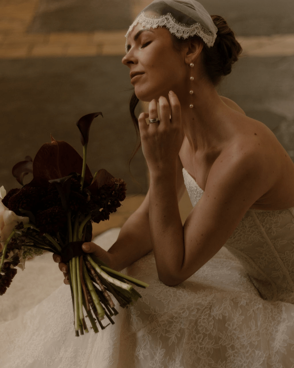 Bride wearing a lace edged tulle short micro veil in Juliet cap veil position, teamed with Dorothy long drop pearl earrings.
