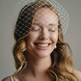 Slim ivory satin headband with attached Birdcage Merry Widow veil