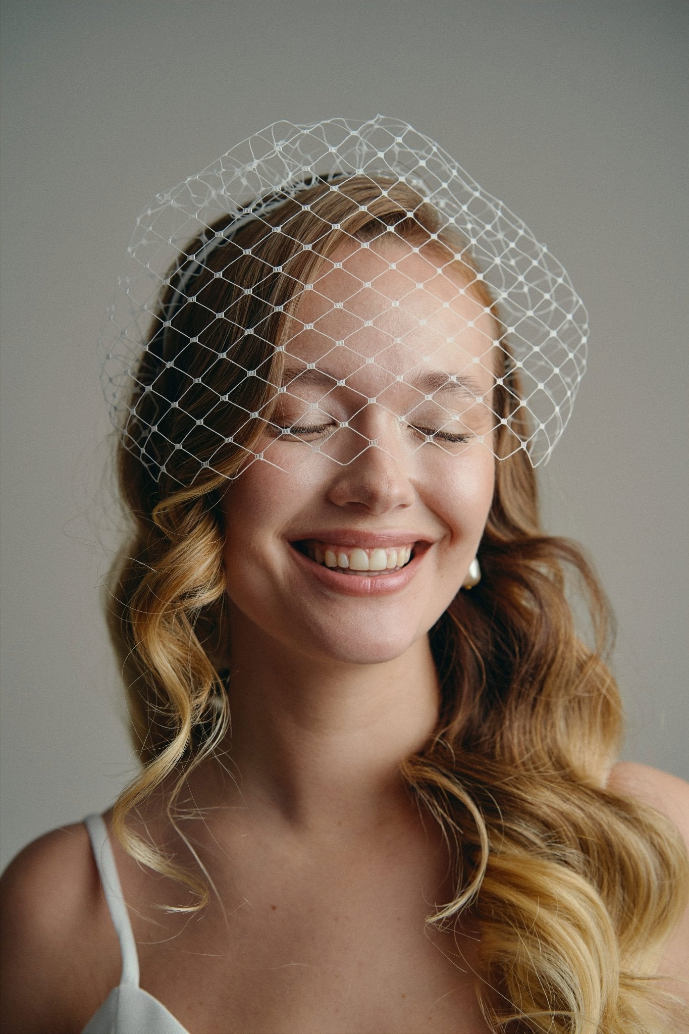 Slim ivory satin headband with attached Birdcage Merry Widow veil