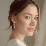 Bride with a low updo wearing the Ina silver pearl drop earrings