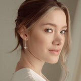 Bride with a low updo wearing the Ina silver pearl drop earrings