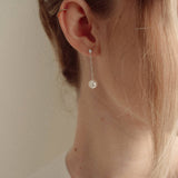 Close-up of a bride wearing a delicate crytal and pearl drop earring silver