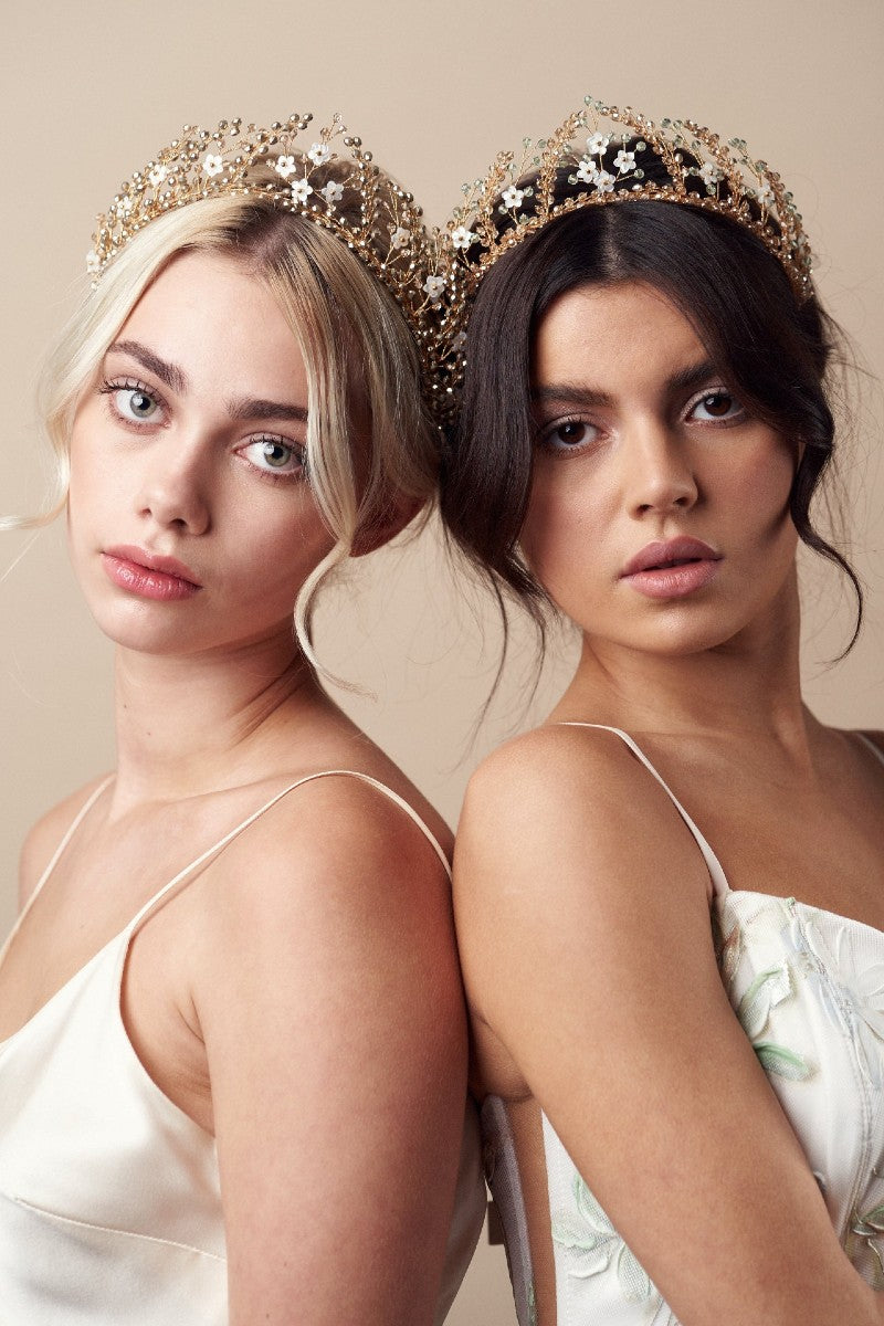 two models wear gold crystal and mother of pearl flower wedding crowns 