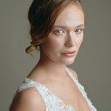 Model wears delicate gold leaf hair vine headband with low bun updo