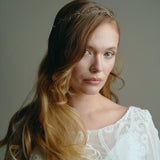 Model wears delicate silver leaf ribbon tie headband hair vine with long lose waves