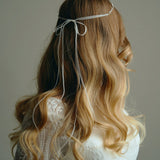 Model wears delicate silver leaf ribbon tie headband hair vine with long lose waves