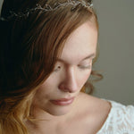 Model wears silver delicate leaf hair vine headband with long hair down