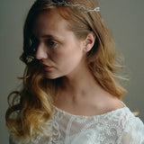 Model wears delicate silver leaf ribbon tie headband hair vine with long lose waves