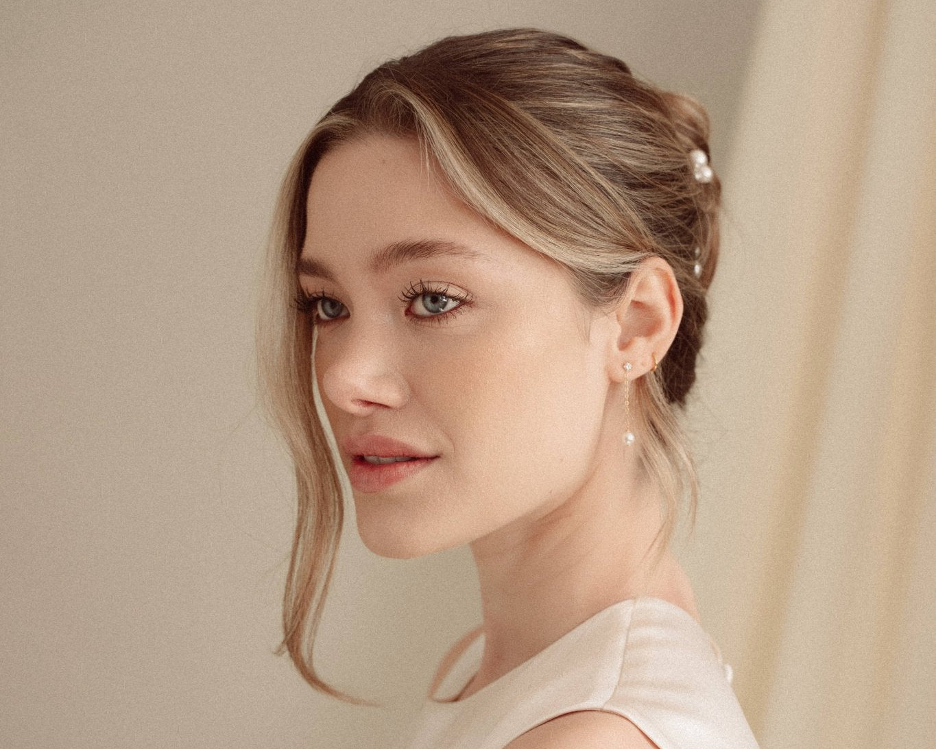 Romantic chignon updo with Perla pearl hair pins and Ina gold crystal drop earrings