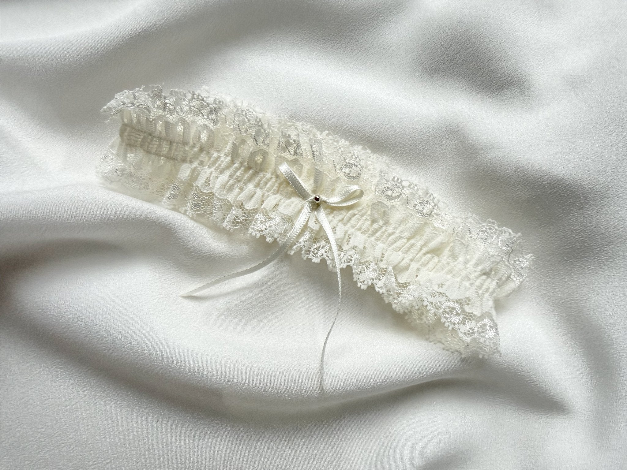 Lace garter on a white fabric background