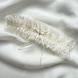 Lace garter on a white fabric background