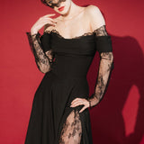 Woman in a black lace dress against a red background wears a black mask style micro veil with a lace edging