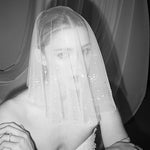 Bride wears a shaeer tulle drop micro veil with pearl and crystal embellishments 