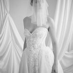Bride wears a sheer tulle drop micro veil with pearl and crystal embellishments 