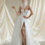 Bride wears a sheer tulle drop micro veil with pearl and crystal embellishments 