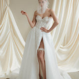 Bride wears a sheer tulle drop micro veil with pearl and crystal embellishments 