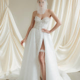 Bride wears a sheer tulle drop micro veil with pearl and crystal embellishments 