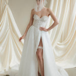Bride wears a sheer tulle drop micro veil with pearl and crystal embellishments 