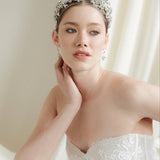 Woman wearing a silver tiara in a softly lit room