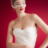 bride wearing a sheer micro veil with lace details against a red background
